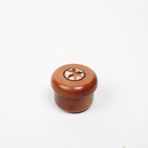 An acorn shaped small box with a yosegi star inlaid on its top