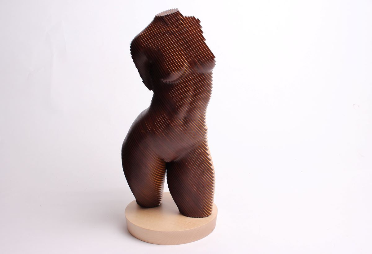 A sculpture of a female torso made from laminations of timber