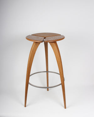 A three legged oak bar stool