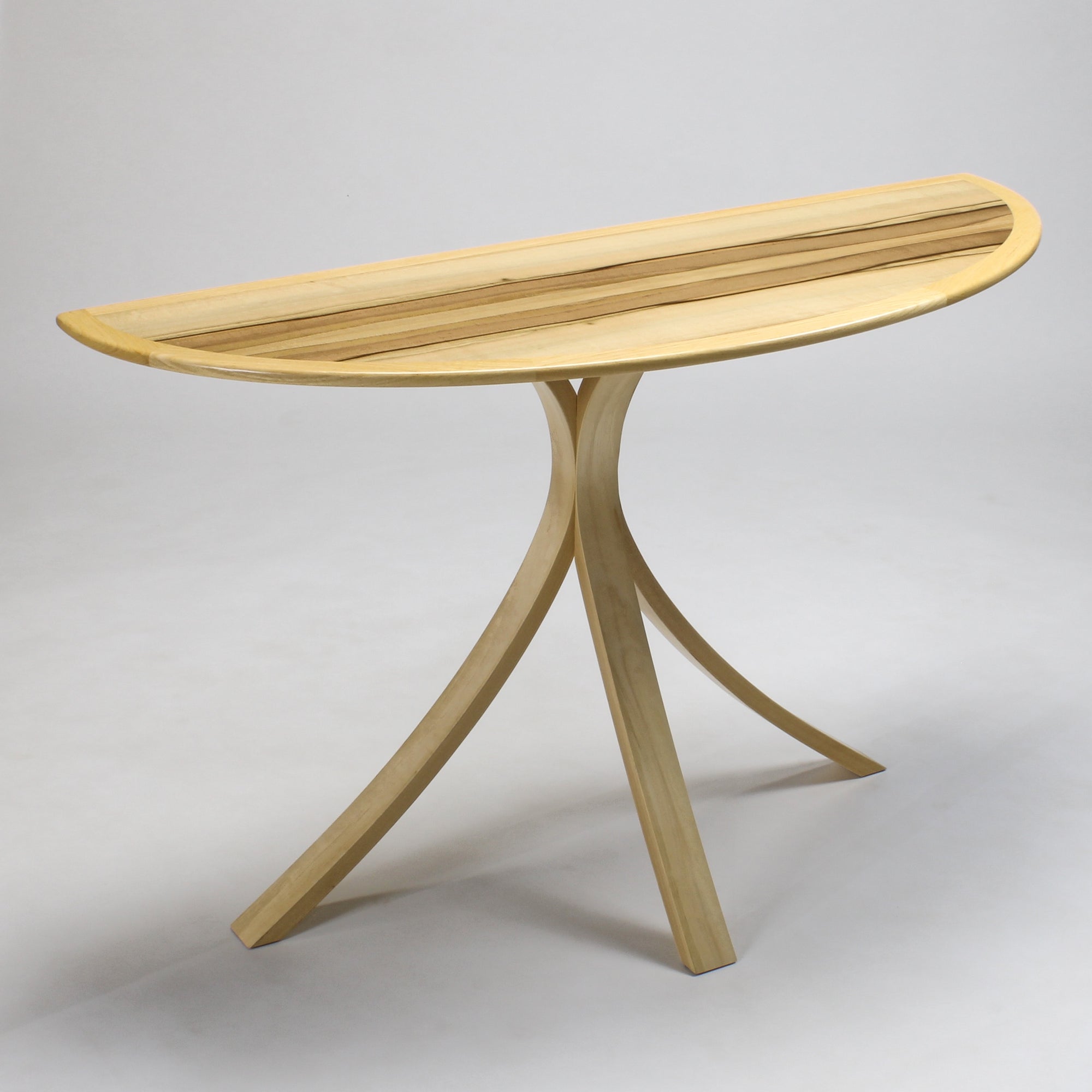 A sassafras hall table with curved top and tripod leg structure